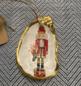 A painted oyster ornament featuring a nutcracker