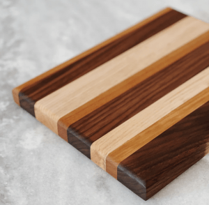 A wooden striped charcuterie board