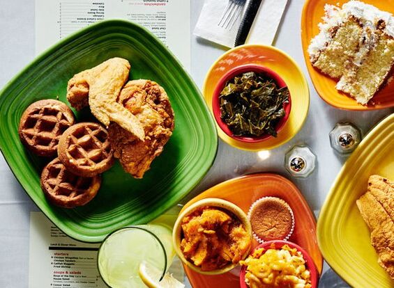 a plate of fried chicken and other soul food dishes at Mama J's