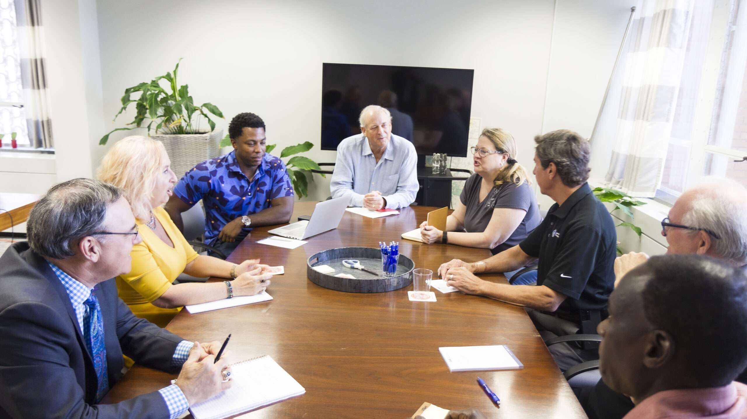 local businesses gathered around a table discussing ideas