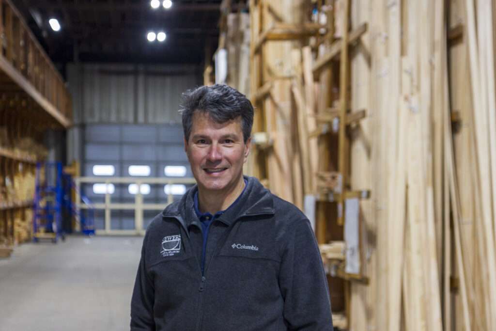 A local business owner in the warehouse of his Richmond lumber and millwork company