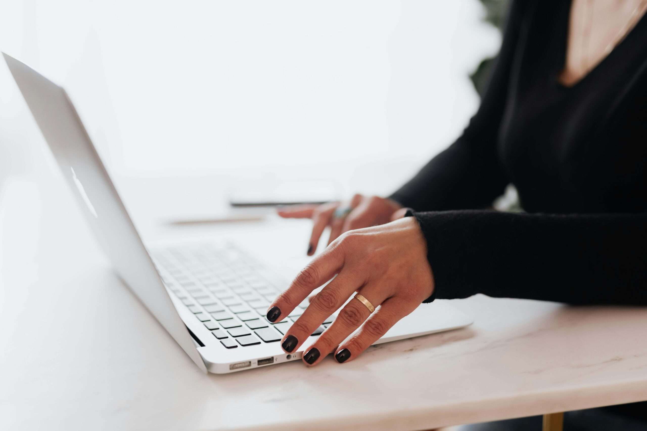 woman typing on computer setting up local SEO