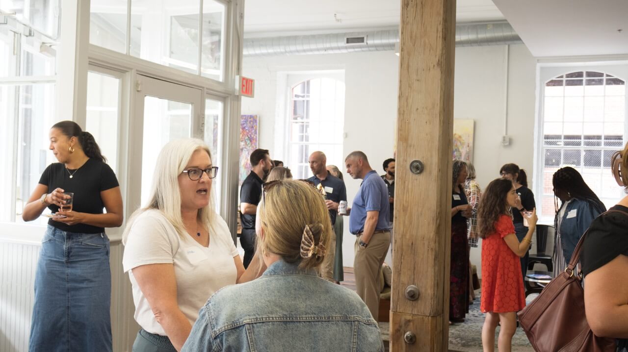 InUnison members talking at a Happier Hour hosted at Sandbox