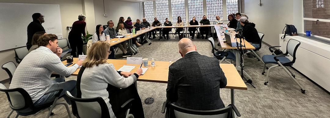 A full room of InUnison members gathered around tables for a panel discussion